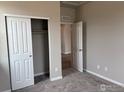 Cozy bedroom showcases a closet, neutral walls, and soft carpeting for comfort at 1783 Jennifer St, Brighton, CO 80601