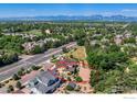Aerial view of house with surrounding landscape, nearby road, and mountain views at 2005 Aster Ln, Lafayette, CO 80026