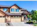 Beautiful home featuring a well-maintained lawn, two-car garage, and lovely front porch at 2005 Aster Ln, Lafayette, CO 80026