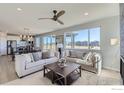 Bright living room showcasing two couches, large windows, and open-concept layout at 2715 Crystal Springs Ln, Longmont, CO 80503