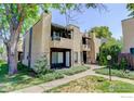 Inviting two-story condo with well-maintained lawn, mature tree, and charming front entrance at 2942 Shady W Holw, Boulder, CO 80304