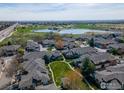 Aerial view of a property showing its surrounding community and scenic views with a lake at 3000 E 112Th Ave # 102, Northglenn, CO 80233