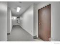 Hallway leading to a door with neutral colors and carpet flooring at 3150 Iris Ave # 303, Boulder, CO 80301
