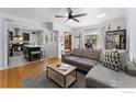 Open-concept living room, hardwood floors, flows to kitchen with eat-in island and stainless appliances at 3730 Lowell Blvd, Denver, CO 80211
