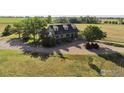 Spacious country home with a well-manicured lawn and large gravel driveway at 420 E County Road 10, Berthoud, CO 80513