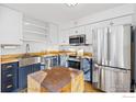 Charming kitchen with butcher block countertops, stainless steel appliances, and farmhouse sink at 5174 Buckingham Rd, Boulder, CO 80301