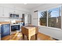 Kitchen with butcher block countertops, stainless steel appliances, and a window overlooking the yard at 5174 Buckingham Rd, Boulder, CO 80301