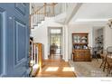 Welcoming foyer with hardwood floors, staircase, and natural light offers a great first impression of the home's interior at 7372 E 129Th Pl, Thornton, CO 80602