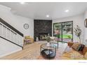 Bright living room featuring a stone fireplace and sliding glass doors to the backyard at 7474 E Arkansas Ave # 12, Denver, CO 80231
