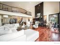 Spacious living room with fireplace, vaulted ceilings, and natural light at 8337 Greenwood Dr, Niwot, CO 80503
