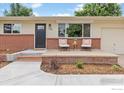 Inviting front porch with brick accents, neutral siding, and a cozy seating area at 1100 Berea Dr, Boulder, CO 80305