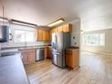 Eat-in kitchen featuring stainless steel appliances, wood cabinets, and wood-look flooring at 11941 S Clayson St, Parker, CO 80138