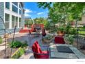 Cozy backyard patio with outdoor seating, a fire pit, and lush landscaping, perfect for entertaining at 23570 E Holly Hills Way, Parker, CO 80138