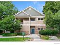 Charming two-story home with stone accents, green lawn, and attractive landscaping at 3350 Boulder Cir # 201, Broomfield, CO 80023