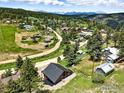 Panoramic aerial view showcasing the charming community nestled amidst lush greenery and distant mountain views at 360 Boulder St, Boulder, CO 80302