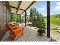 Relaxing covered porch featuring cozy seating and views of the lush green landscape at 360 Boulder St, Boulder, CO 80302