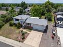 A house, shot from above, sits on a large lot with a two-car garage and updated roof at 3792 E 114Th Dr, Thornton, CO 80233