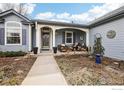 Inviting covered front porch with seating area and decorative plants, perfect for relaxation at 4644 W 112Th Ct, Westminster, CO 80031