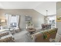 Bright living room with high ceilings, plush carpeting, and stylish furnishings at 4644 W 112Th Ct, Westminster, CO 80031