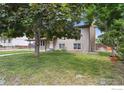A inviting single-Gathering home with a lush green lawn and mature trees at 4655 Macky Way, Boulder, CO 80305