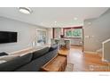 Bright and airy living room with modern hardwood floors and an open kitchen at 4655 Macky Way, Boulder, CO 80305