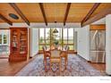 Dining room showcases a beamed ceiling, large windows with a view, and vintage cabinet at 474 Leonards Rd, Boulder, CO 80302