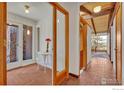 Inviting foyer features brick floors, stone wall accents and natural light streaming through large windows at 474 Leonards Rd, Boulder, CO 80302
