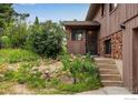 Exterior shot of the home featuring a welcoming entrance and charming landscaping at 853 Deer Trail Rd, Boulder, CO 80302