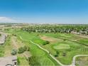 Scenic aerial view of the community golf course and surrounding neighborhood on a sunny day at 12912 Grant E Cir # A, Thornton, CO 80241