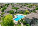 Aerial view of a sparkling community pool surrounded by well-manicured landscaping and neighborhood homes at 12912 Grant E Cir # A, Thornton, CO 80241