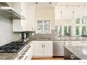 Bright, contemporary kitchen featuring stainless steel appliances and gray subway tile backsplash at 1323 Swallow Ct, Boulder, CO 80303
