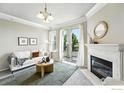 Inviting living room featuring a fireplace, comfortable sofa, and access to a private balcony at 1876 Mallard Dr, Louisville, CO 80027