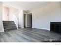 Bright living room featuring laminate floors, staircase and fireplace at 3051 Craft Way, Westminster, CO 80030