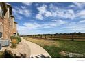 Scenic walking path next to the property's well-maintained exterior and neighboring pasture land at 3155 Blue Sky Cir # 16-103, Erie, CO 80516