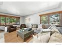 Bright living room with multiple windows, cozy seating, and stylish decor elements at 610 S Miller Ave, Lafayette, CO 80026