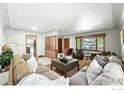 Spacious living room featuring neutral walls, large windows, and comfortable seating arrangements at 610 S Miller Ave, Lafayette, CO 80026