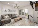 Comfortable living room featuring a plush sofa, stylish rug, and plenty of natural light at 619 Brennan Cir, Erie, CO 80516