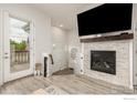 Cozy living area with a modern fireplace and mounted TV, perfect for relaxing at 619 Brennan Cir, Erie, CO 80516