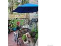 Relaxing outdoor deck area with a grill, umbrella, and potted plants, creating a peaceful retreat at 6504 Ralston Rd, Arvada, CO 80002