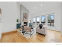 Bright living room with a fireplace, light hardwood floors and modern furniture at 6668 Walker Ct, Niwot, CO 80503
