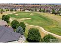 Beautiful golf course view from a home featuring a deck and mature trees at 8305 E 149Th Dr, Thornton, CO 80602