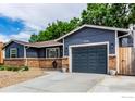 Charming single-story home featuring a brick facade, a two-car garage, and a concrete driveway at 8696 W 86Th Cir, Arvada, CO 80005