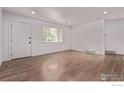 Bright living room featuring wood floors, white walls, and a large window at 8696 W 86Th Cir, Arvada, CO 80005