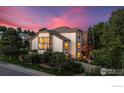 The rear exterior features a cozy deck and lush greenery, creating a private backyard retreat at 888 Northern Way, Superior, CO 80027