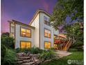 The rear exterior offers a spacious deck, tiered landscaping, and inviting outdoor living space at 888 Northern Way, Superior, CO 80027