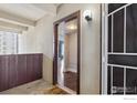Condo entrance showing door, exterior light, and partial view into the main living space at 9995 E Harvard Ave, Denver, CO 80231