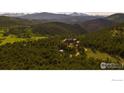 Expansive aerial view of a secluded home surrounded by lush forest at 11780 Gold Hill Rd, Boulder, CO 80302