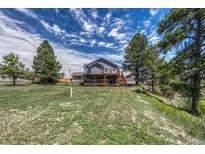 Expansive backyard with mature trees and well-maintained lawn offers plenty of space at 10534 Inspiration Dr, Parker, CO 80138