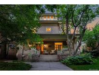 Charming home featuring a welcoming front porch with stone steps and decorative swan planters at 780 N Lafayette St, Denver, CO 80218