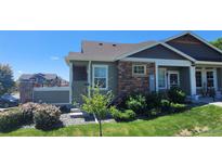 Charming single-Gathering home featuring stone accents, manicured landscaping, and a welcoming entrance at 12940 Jasmine St # A, Thornton, CO 80602